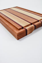 Load image into Gallery viewer, Large cutting board with strips of cherry, purpleheart and maple wood featuring a juice groove.
