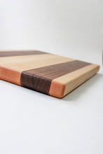 Load image into Gallery viewer, Handmade cutting board with alternating strips of walnut and hard maple wood.
