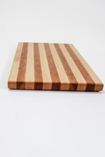 Load image into Gallery viewer, Handmade cutting board with alternating strips of cherry and hard maple wood.
