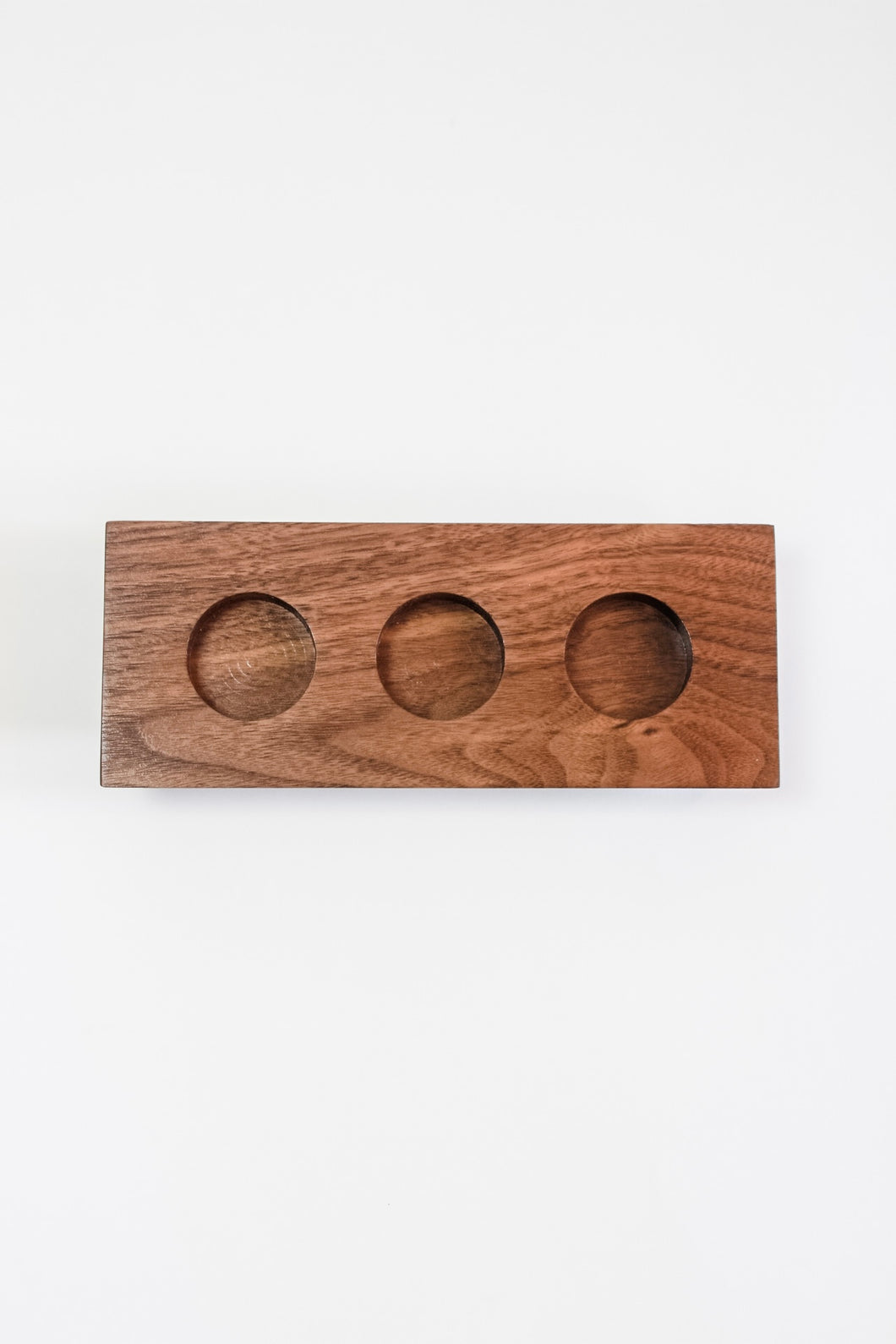 Solid walnut 3-hole tealight candle holder featuring maple accents.